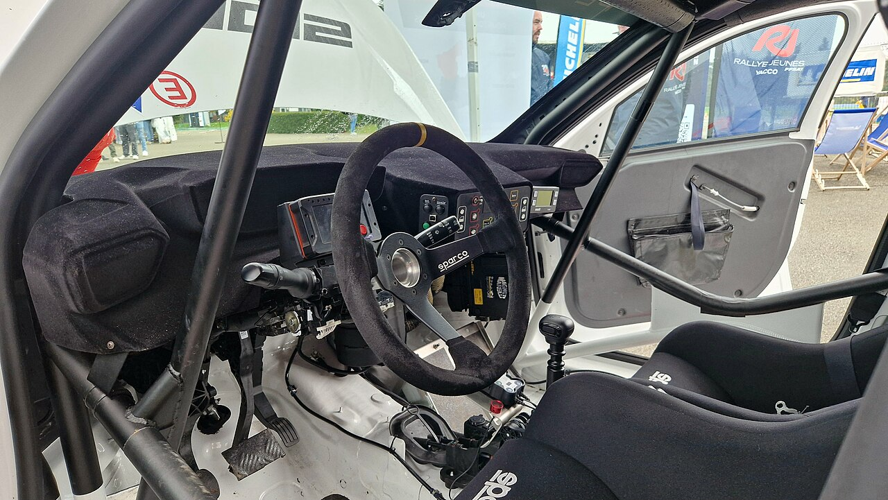 Cockpit de la Peugeot 208 Rally6 : volant Sparco, arceau et baquet